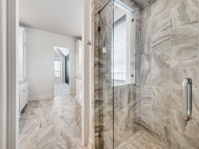 2911 Blackthorn Dr, Prosper, TX 75078 - bathroom featuring a tile shower, vanity, and marble finish flooring