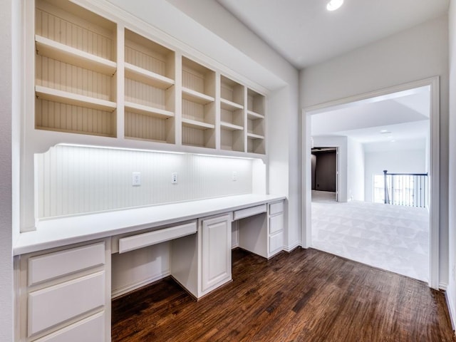 2911 Blackthorn Dr, Prosper, TX 75078 - unfurnished office featuring built in study area, dark wood-style flooring, and dark colored carpet