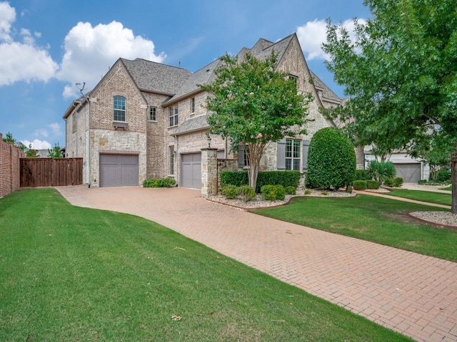 2911 Blackthorn Dr, Prosper, TX 75078 - view of front of house featuring stone siding, decorative driveway, a garage, and brick siding