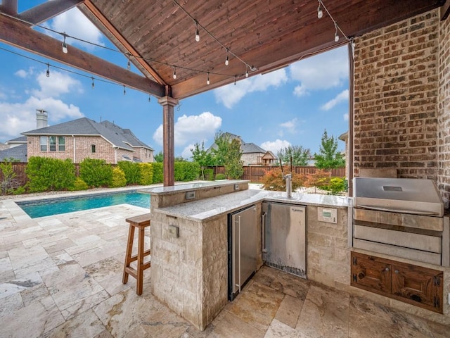 2911 Blackthorn Dr, Prosper, TX 75078 - fenced backyard with exterior kitchen and a patio