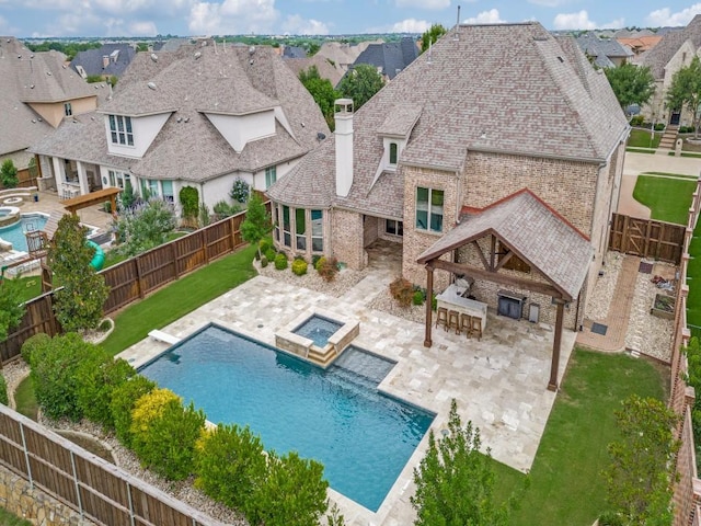 2911 Blackthorn Dr, Prosper, TX 75078 - view of swimming pool with a fenced backyard, a pool with connected hot tub, and a patio