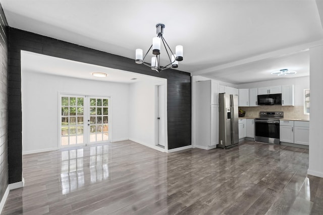 4236 Virginia Ln, Fort Worth, TX 76103 - unfurnished living room with dark wood-style floors, a chandelier, and french doors