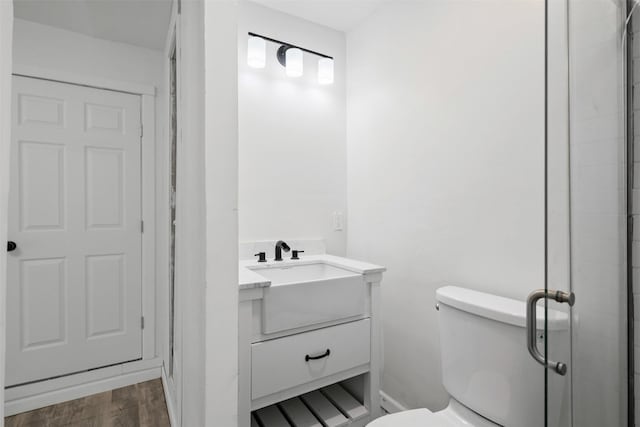 4236 Virginia Ln, Fort Worth, TX 76103 - bathroom featuring vanity, wood finished floors, and a shower with door