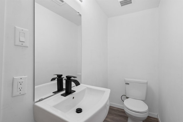 4236 Virginia Ln, Fort Worth, TX 76103 - bathroom with toilet and wood finished floors