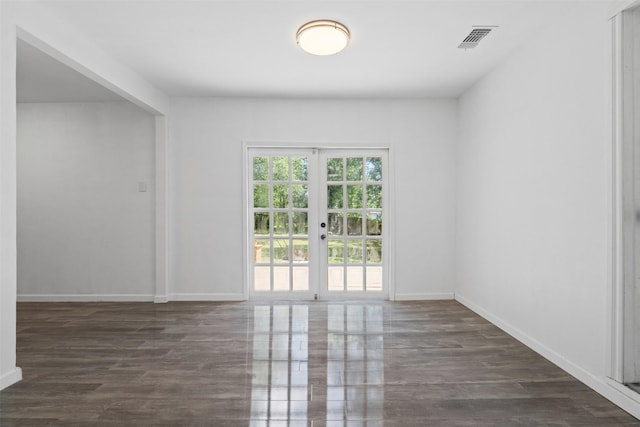4236 Virginia Ln, Fort Worth, TX 76103 - spare room featuring french doors and dark wood finished floors