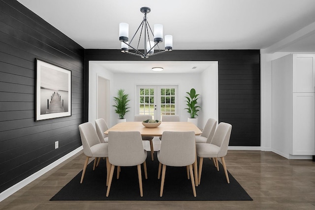4236 Virginia Ln, Fort Worth, TX 76103 - dining space featuring dark wood-style flooring, a chandelier, and wood walls
