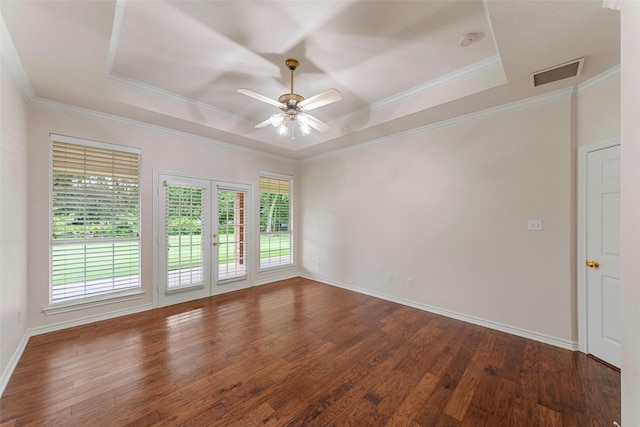 2403 Berry Grove Ct, Melissa, TX 75454 - empty room with a raised ceiling, dark wood-style flooring, ceiling fan, crown molding, and a smoke detector