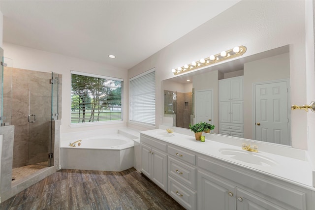 2403 Berry Grove Ct, Melissa, TX 75454 - bathroom featuring a garden tub, double vanity, a stall shower, wood finished floors, and recessed lighting
