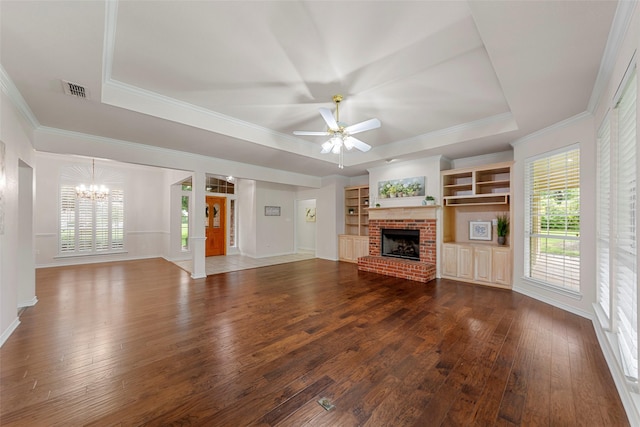 2403 Berry Grove Ct, Melissa, TX 75454 - unfurnished living room featuring a chandelier, a raised ceiling, dark wood-type flooring, a fireplace, and ornamental molding