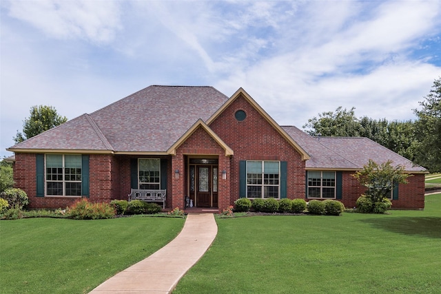 206 Hidden Meadow Cir, Midlothian, TX 76065 - view of front of house featuring brick siding, a front lawn, a porch, and a shingled roof