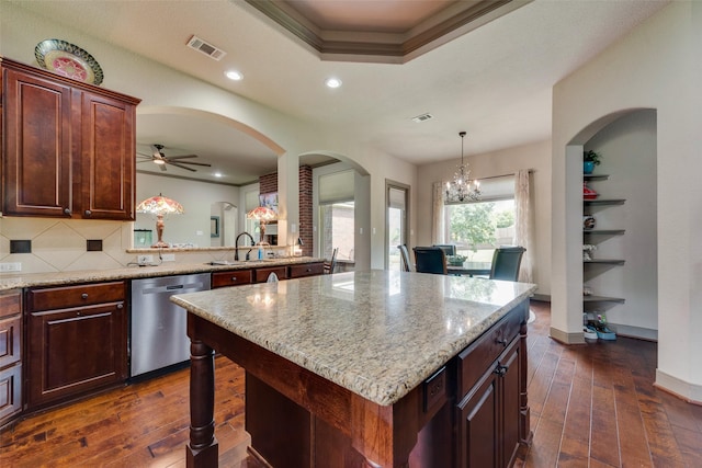 206 Hidden Meadow Cir, Midlothian, TX 76065 - kitchen featuring dishwasher, dark wood-style floors, decorative backsplash, light stone counters, and a kitchen island