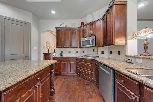 206 Hidden Meadow Cir, Midlothian, TX 76065 - kitchen with stainless steel appliances, dark wood-style flooring, light stone countertops, and backsplash