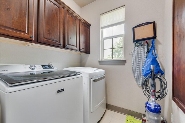 206 Hidden Meadow Cir, Midlothian, TX 76065 - washroom featuring cabinet space, washing machine and dryer, and light tile patterned floors
