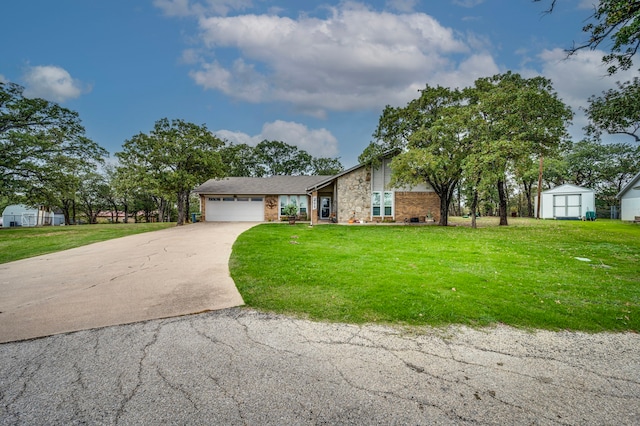 211 Willow Creek Ct, Mansfield, TX 76063 - view of front facade featuring a storage unit, an attached garage, driveway, a front yard, and stone siding