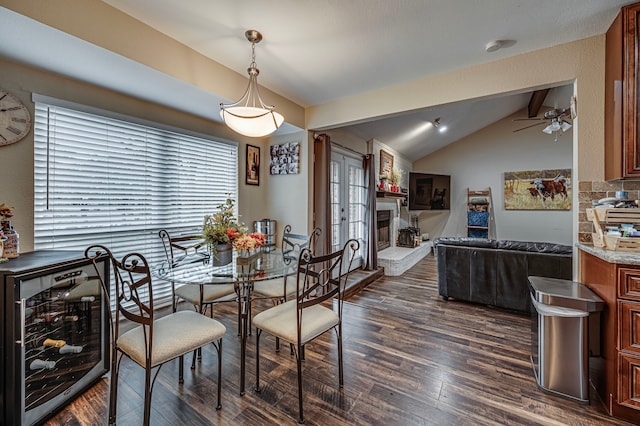 211 Willow Creek Ct, Mansfield, TX 76063 - dining area featuring beverage cooler, dark wood-style flooring, ceiling fan, and a fireplace with raised hearth
