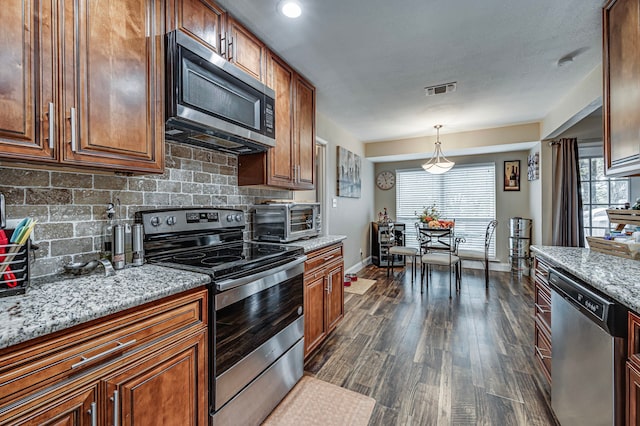 211 Willow Creek Ct, Mansfield, TX 76063 - kitchen with appliances with stainless steel finishes, dark wood-type flooring, tasteful backsplash, healthy amount of natural light, and recessed lighting