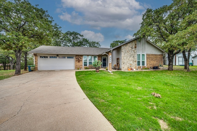 211 Willow Creek Ct, Mansfield, TX 76063 - view of front facade with an attached garage, concrete driveway, a front yard, brick siding, and stone siding
