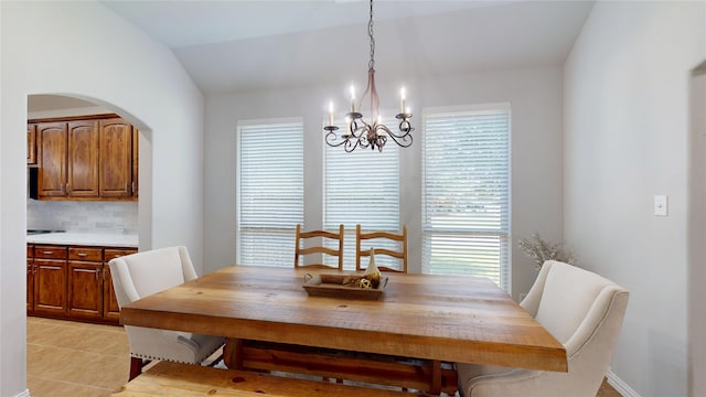 751 Kirby Dr, Argyle, TX 76226 - dining room with a chandelier, light tile patterned floors, vaulted ceiling, and arched walkways