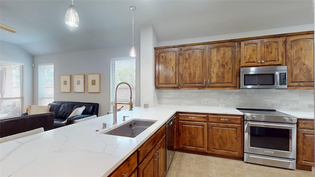 751 Kirby Dr, Argyle, TX 76226 - kitchen featuring stainless steel appliances, light stone counters, pendant lighting, tasteful backsplash, and lofted ceiling