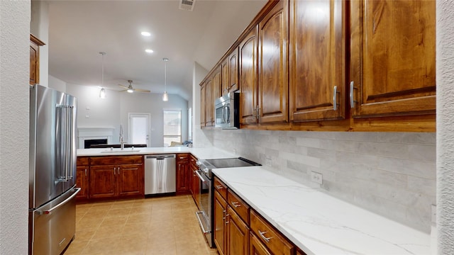 751 Kirby Dr, Argyle, TX 76226 - kitchen with appliances with stainless steel finishes, tasteful backsplash, ceiling fan, light stone counters, and light tile patterned floors