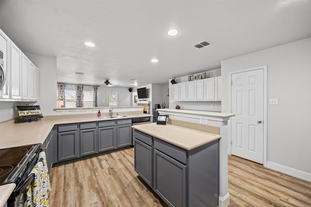 2316 Cavalry Dr, Fort Worth, TX 76177 - kitchen featuring gray cabinetry, a peninsula, light wood-type flooring, light countertops, and white cabinetry