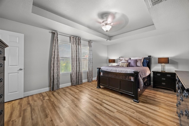 2316 Cavalry Dr, Fort Worth, TX 76177 - bedroom featuring a tray ceiling, light wood-style floors, and a ceiling fan