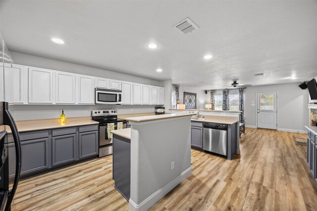 2316 Cavalry Dr, Fort Worth, TX 76177 - kitchen with appliances with stainless steel finishes, a center island, gray cabinetry, light countertops, and recessed lighting