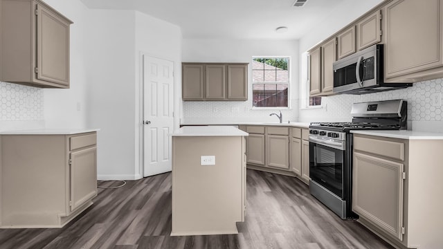 836 Snapdragon Ln, Plano, TX 75075 - kitchen with stainless steel appliances, tasteful backsplash, dark wood-style flooring, and a kitchen island