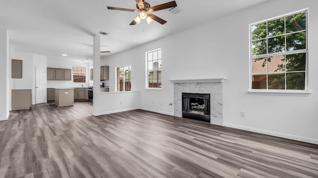 836 Snapdragon Ln, Plano, TX 75075 - unfurnished living room featuring a ceiling fan, wood finished floors, and a premium fireplace