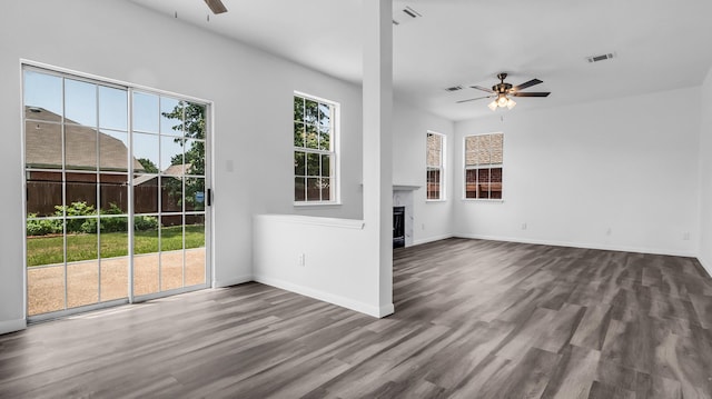 836 Snapdragon Ln, Plano, TX 75075 - unfurnished living room with ceiling fan, a fireplace, and dark wood-style floors