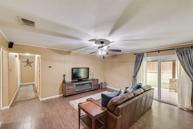 4204 Shipley Ct, Benbrook, TX 76116 - living area featuring wood finished floors, crown molding, a ceiling fan, and a textured ceiling