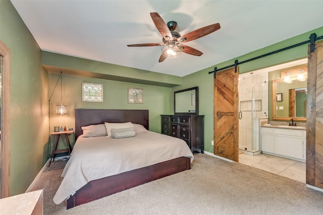 4204 Shipley Ct, Benbrook, TX 76116 - bedroom featuring a barn door, light colored carpet, ensuite bath, and a ceiling fan