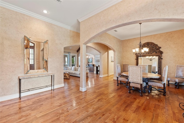 229 Lakeside Dr, Malakoff, TX 75148 - dining area featuring arched walkways, wood finished floors, a chandelier, crown molding, and recessed lighting