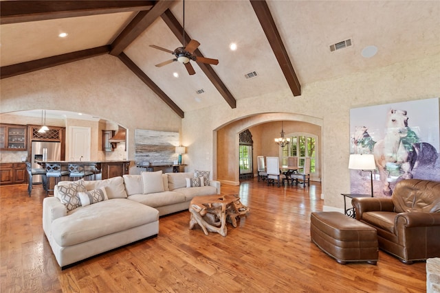229 Lakeside Dr, Malakoff, TX 75148 - living room featuring arched walkways, a chandelier, high vaulted ceiling, light wood-type flooring, and beam ceiling