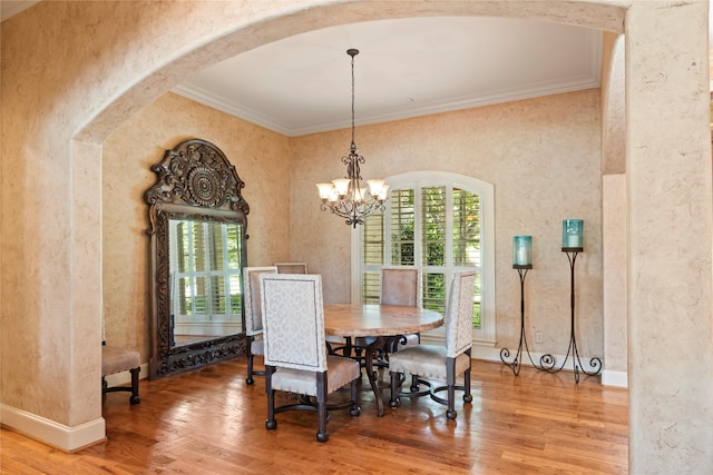 229 Lakeside Dr, Malakoff, TX 75148 - dining space with arched walkways, plenty of natural light, wood finished floors, ornamental molding, and a chandelier