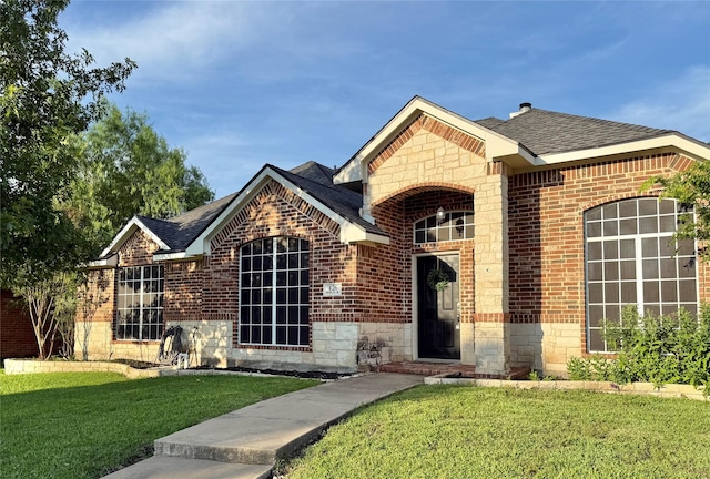 426 Bell Dr, Wylie, TX 75098 - view of front of property featuring brick siding, a front lawn, a shingled roof, and stone siding