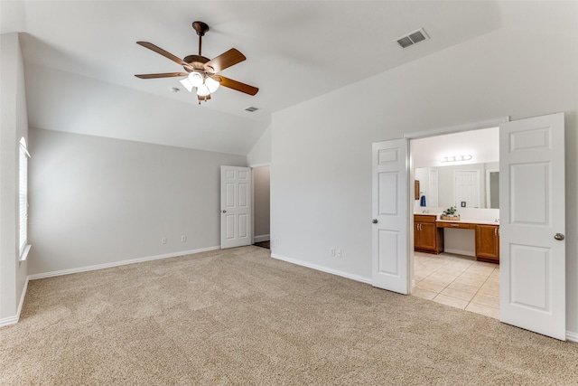 426 Bell Dr, Wylie, TX 75098 - unfurnished bedroom with light colored carpet, vaulted ceiling, ensuite bathroom, light tile patterned floors, and a ceiling fan