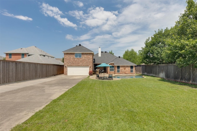 426 Bell Dr, Wylie, TX 75098 - back of house with concrete driveway, brick siding, a garage, and a fenced backyard