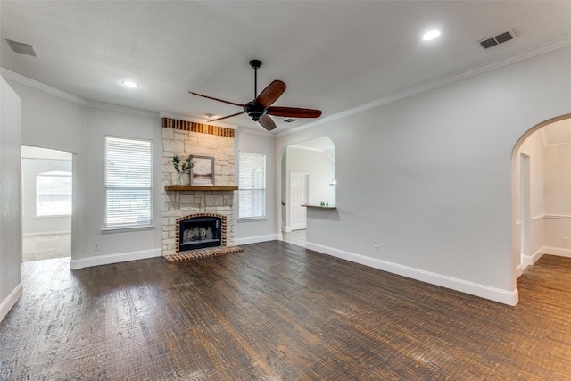 426 Bell Dr, Wylie, TX 75098 - unfurnished living room featuring a ceiling fan, healthy amount of natural light, crown molding, arched walkways, and dark wood-type flooring