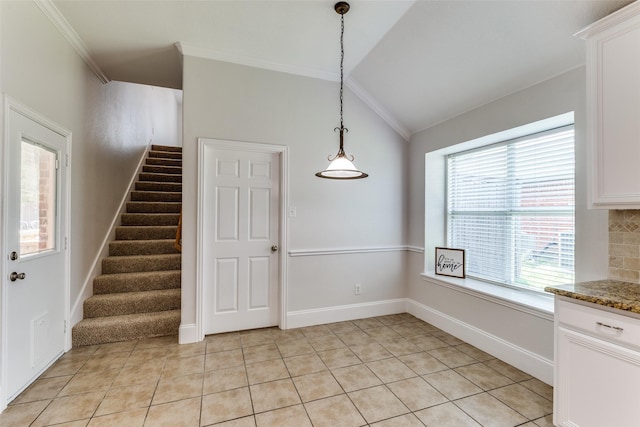 426 Bell Dr, Wylie, TX 75098 - unfurnished dining area with lofted ceiling, crown molding, stairway, and light tile patterned floors