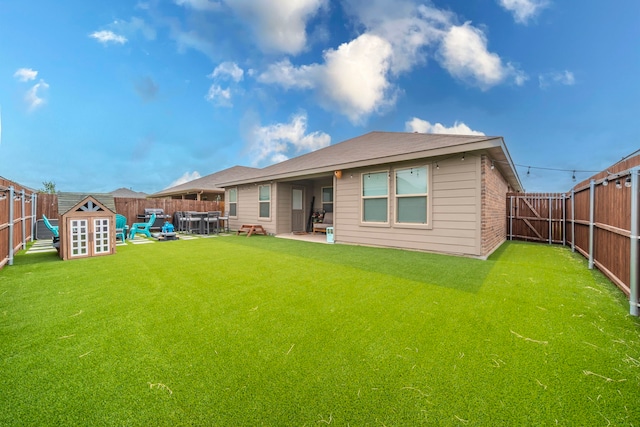 756 Loomis Trl, Justin, TX 76247 - rear view of house with a fenced backyard, a storage shed, brick siding, and a patio area
