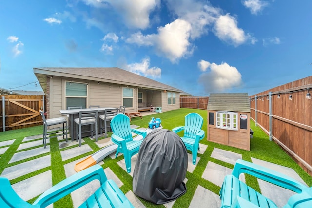 756 Loomis Trl, Justin, TX 76247 - fenced backyard featuring a patio area, an outbuilding, and outdoor dining space
