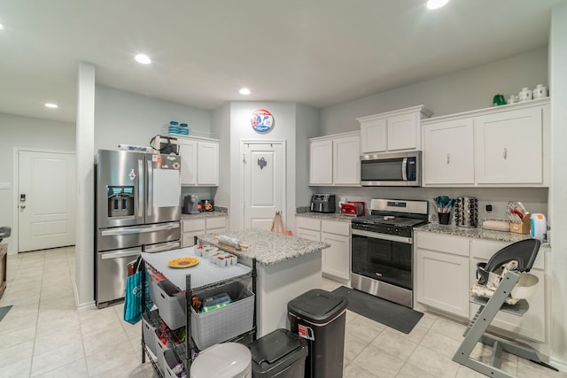 756 Loomis Trl, Justin, TX 76247 - kitchen with stainless steel appliances, white cabinetry, light stone countertops, light tile patterned floors, and recessed lighting