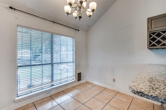 3412 Forest Creek Dr, Fort Worth, TX 76123 - unfurnished dining area with vaulted ceiling, a chandelier, and light tile patterned flooring