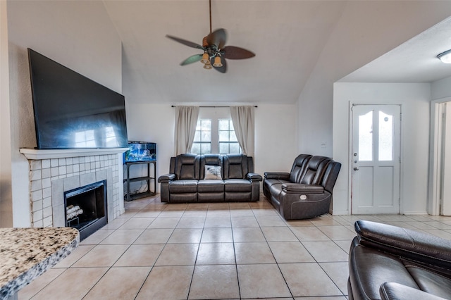 3412 Forest Creek Dr, Fort Worth, TX 76123 - living area featuring a ceiling fan, lofted ceiling, a tiled fireplace, light tile patterned flooring, and healthy amount of natural light