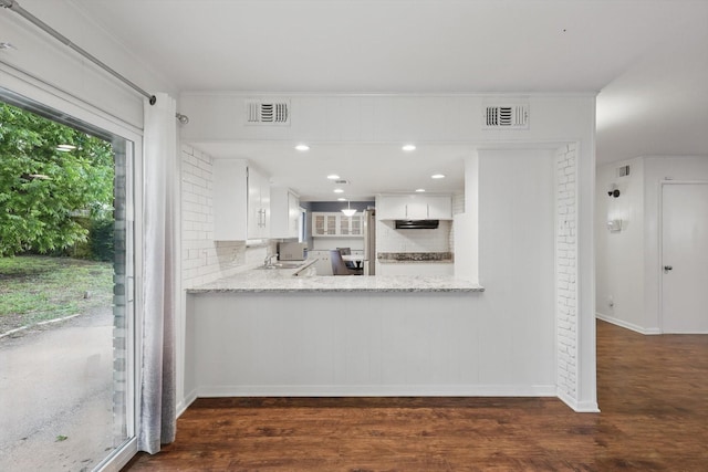 6123 Moonglow Dr, Dallas, TX 75241 - kitchen with dark wood-style flooring, white cabinets, light stone countertops, a peninsula, and recessed lighting