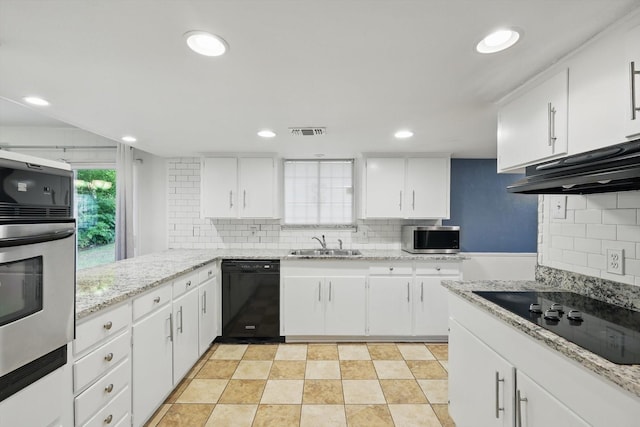 6123 Moonglow Dr, Dallas, TX 75241 - kitchen with black appliances, decorative backsplash, white cabinetry, light stone countertops, and recessed lighting