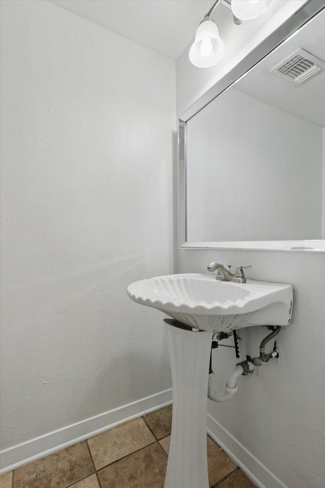 6123 Moonglow Dr, Dallas, TX 75241 - bathroom with baseboards and tile patterned flooring