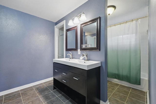 6123 Moonglow Dr, Dallas, TX 75241 - bathroom with double vanity, shower / bath combo with shower curtain, tile patterned floors, and a textured wall
