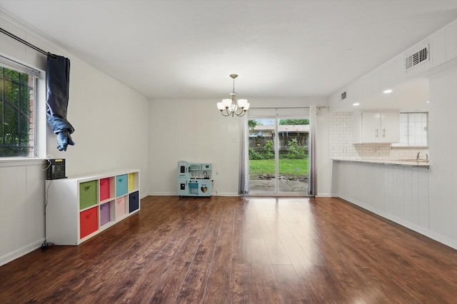 6123 Moonglow Dr, Dallas, TX 75241 - unfurnished living room featuring a chandelier and wood finished floors